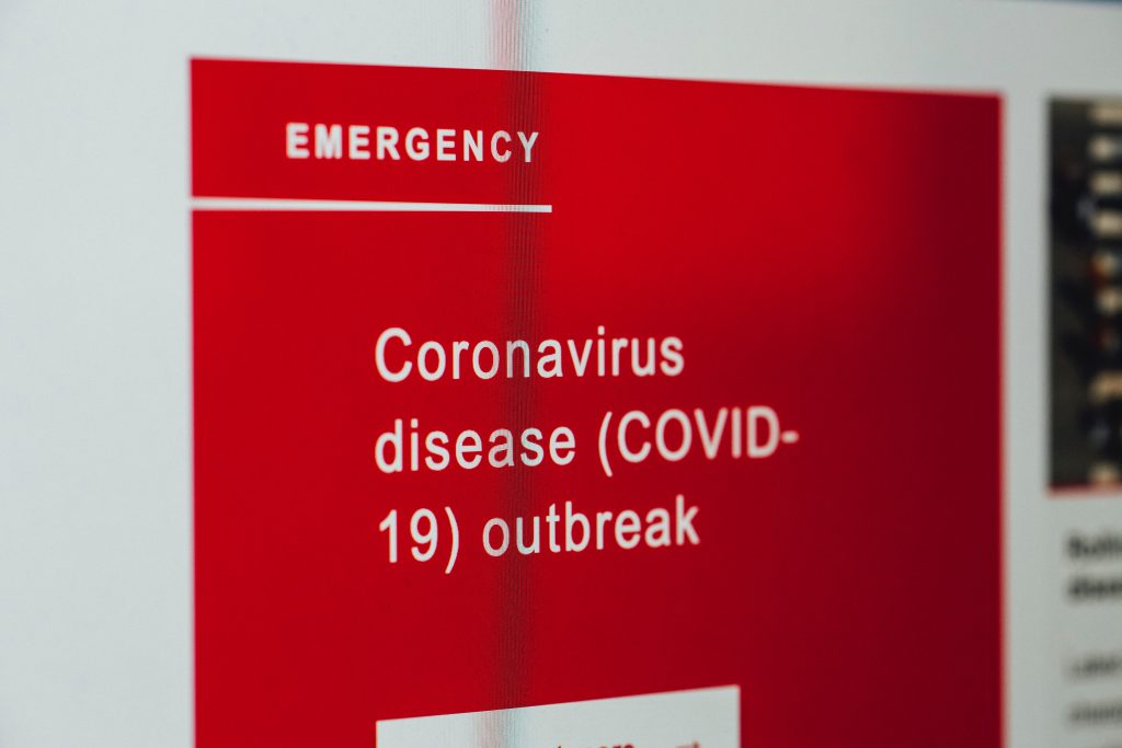 Close up of hospital sign pointing to the COVID-19 ward